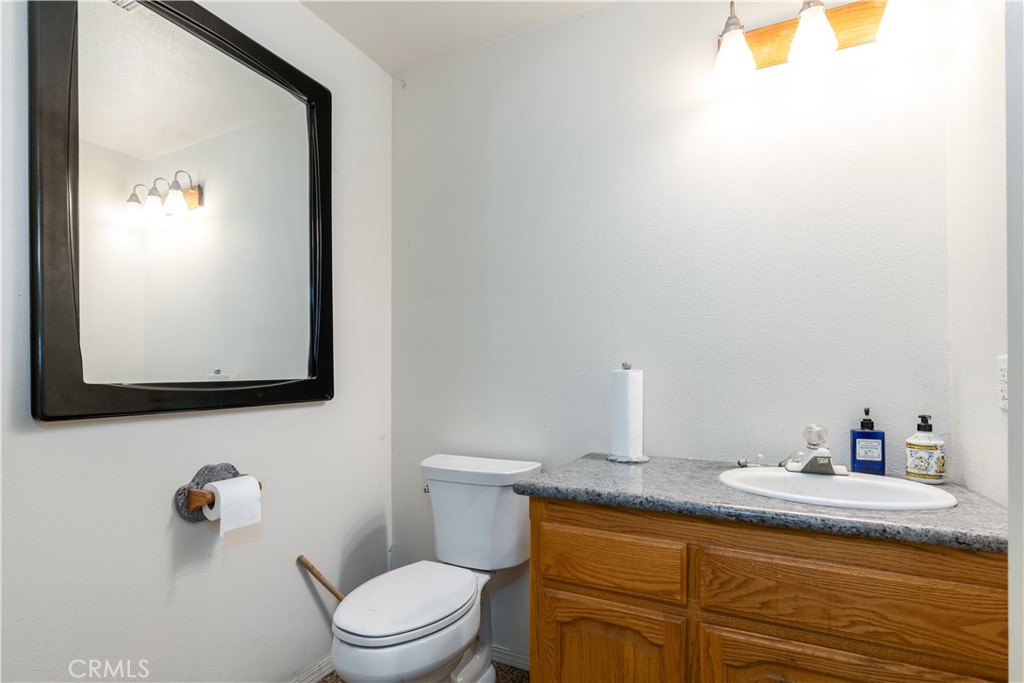 4375 Rustic Way San Luis Obispo, CA 93401 - Photo 59 of 65 a bathroom with a toilet sink vanity and mirror