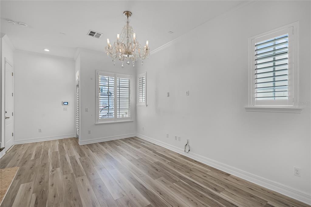 1515 Resolute Street Celebration, FL 34747 - Photo 14 of 56 wooden floor in an empty room with a window