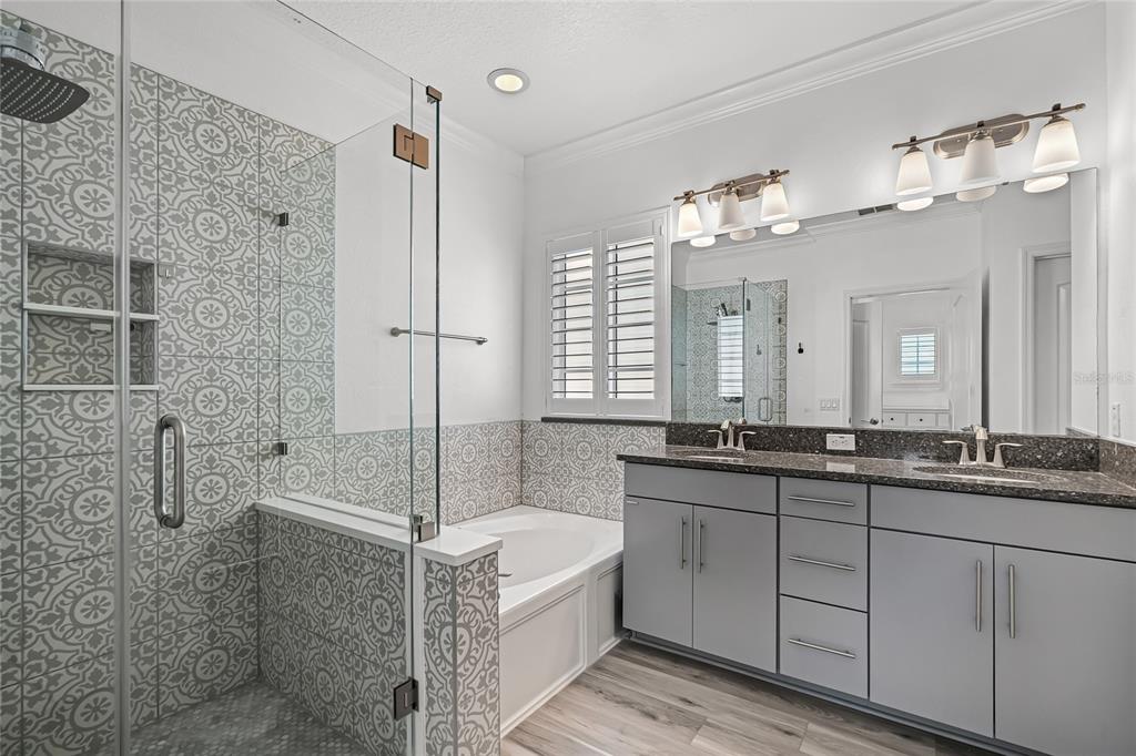 1515 Resolute Street Celebration, FL 34747 - Photo 24 of 56 a bathroom with a granite countertop sink a large mirror and shower