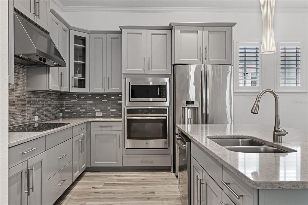 1515 Resolute Street Celebration, FL 34747 - Photo 9 of 56 a kitchen with a sink cabinets and stainless steel appliances