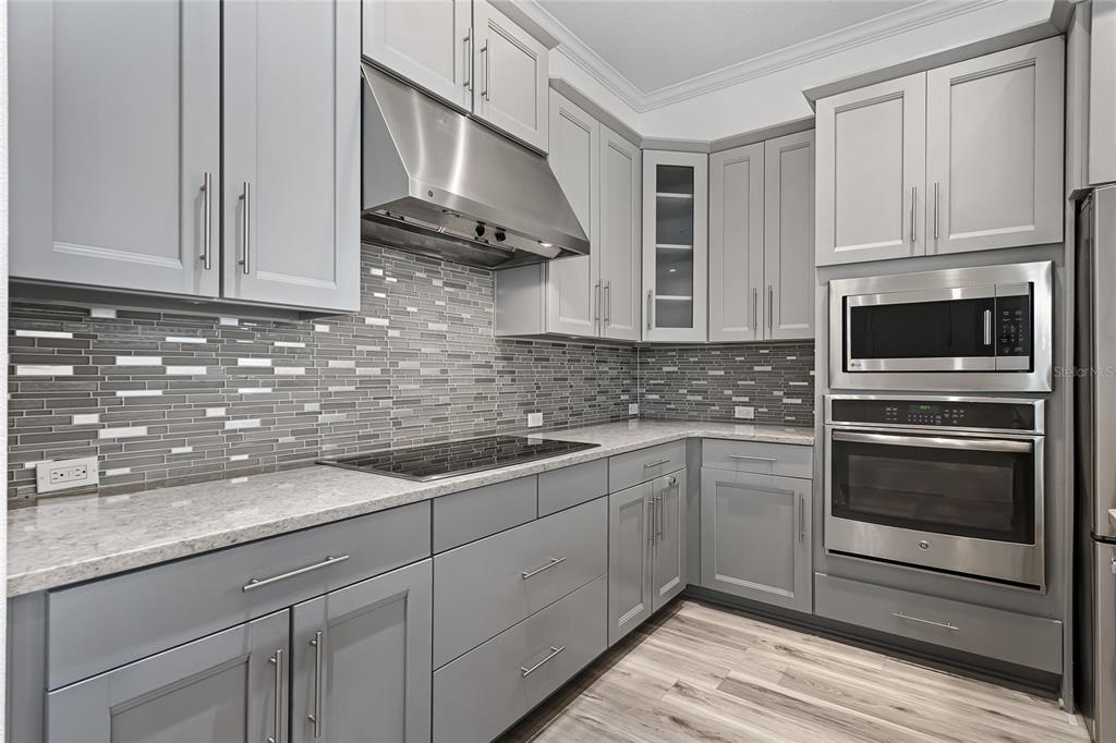 1515 Resolute Street Celebration, FL 34747 - Photo 10 of 56 a kitchen with stainless steel appliances granite countertop a sink and a stove