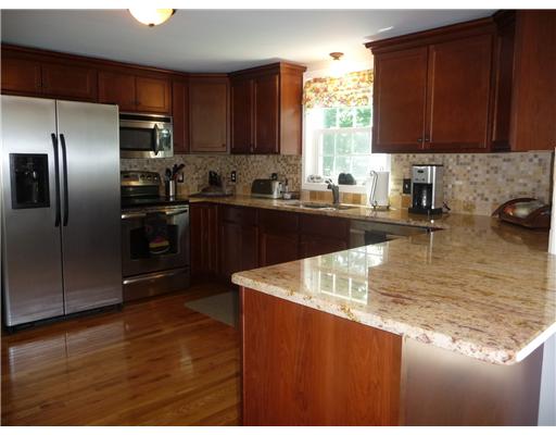 67 Maple Street Coventry, RI 02816 - Photo 3 of 12 Kitchen. Sun filled kitchen over looks expansive beautiful 1 acre rear yard.