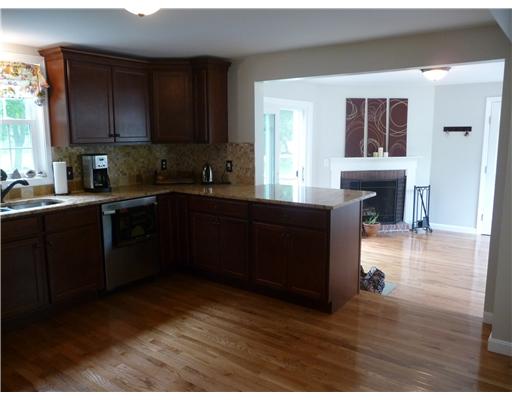 67 Maple Street Coventry, RI 02816 - Photo 5 of 12 Kitchen. Kithchen is open to living room or dining room with fireplace. Sliders open to deck and rear yard. Sunny and bright rooms.