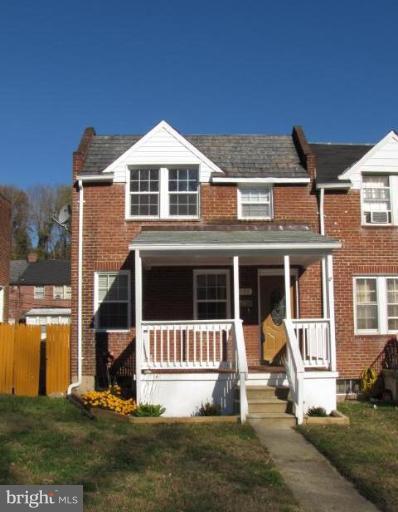 a view of a house with a yard and large tree