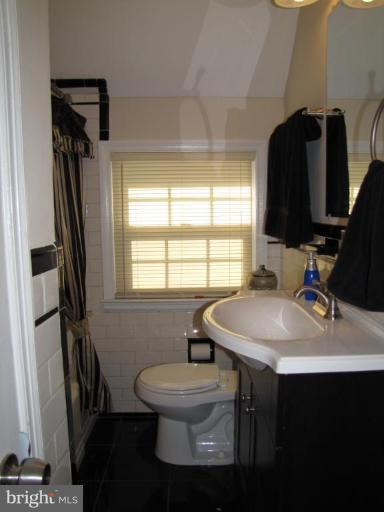 5152 Stafford Road Baltimore, MD 21229 - Photo 15 of 22 a bathroom with a sink toilet and a mirror