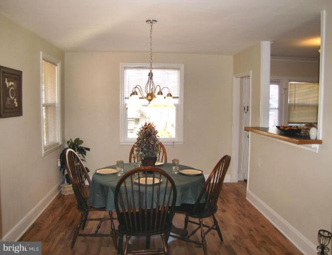 5152 Stafford Road Baltimore, MD 21229 - Photo 4 of 22 a view of a dining room with furniture window and wooden floor