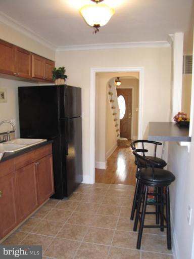 5152 Stafford Road Baltimore, MD 21229 - Photo 8 of 22 a kitchen with stainless steel appliances kitchen island granite countertop a refrigerator and a stove