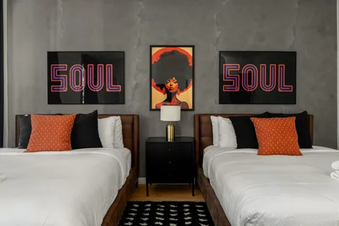 a bed room with double bed and a painting on the wall