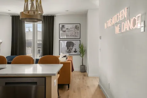 a living room with furniture and a chandelier
