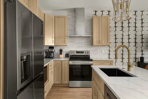 a kitchen with a stove sink and refrigerator