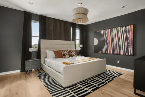 a living room with a bed and a chandelier