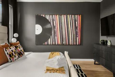 a bedroom with a bed and flat screen tv