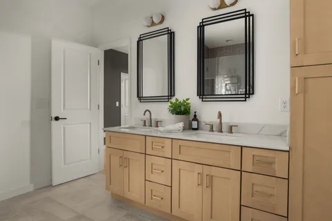 a bathroom with double sink and a mirror