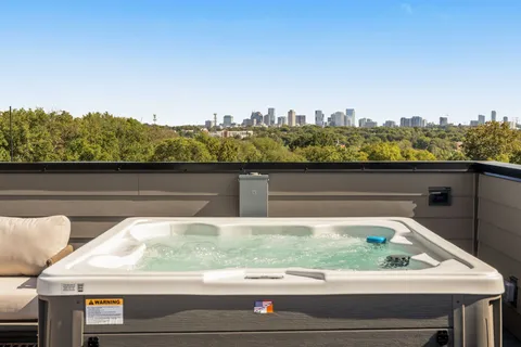a view of roof with furniture and city view