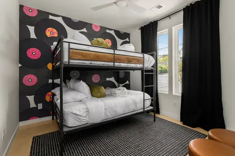 a bedroom with a bed and wooden floor