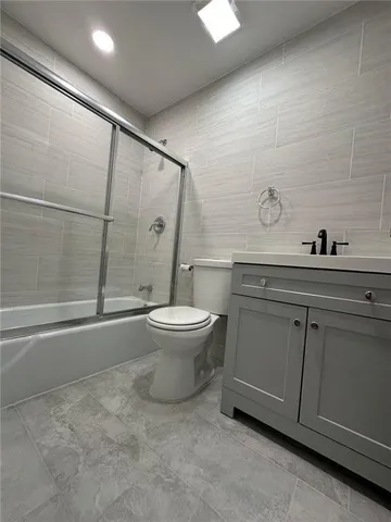 a bathroom with a toilet sink and shower