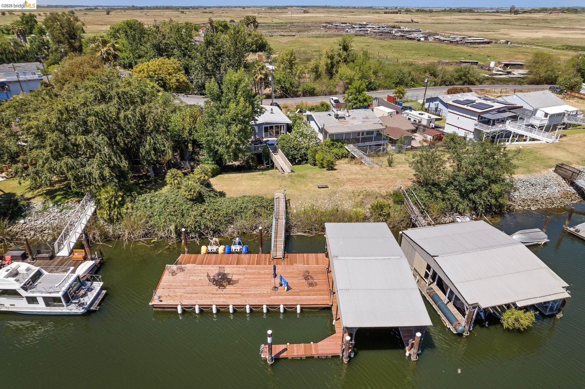 1704 Taylor Road Bethel Island, CA 94511 - Photo 66 of 73 Waterfront property featuring a private boat dock, two covered boat slips, and direct water access