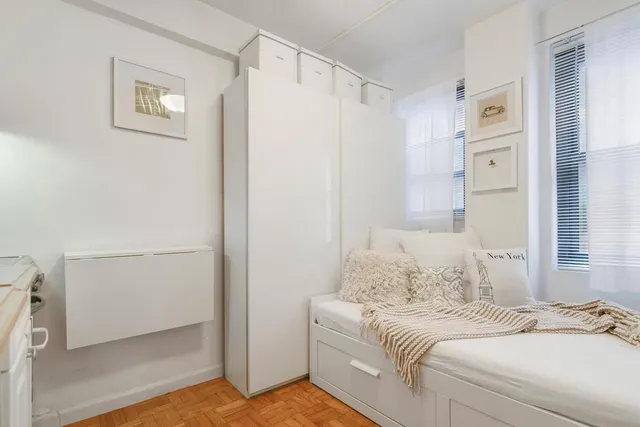 a room with a bed and a window