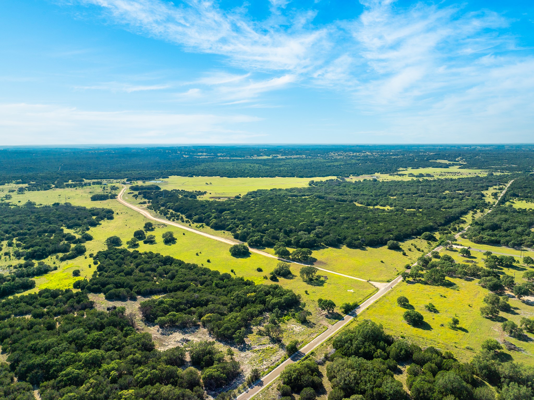 32 Feild Ranch Road Burnet, TX 78611 - Photo 2 of 40 An aerial panorama reveals verdant acreage, perfect for building your dream estate.