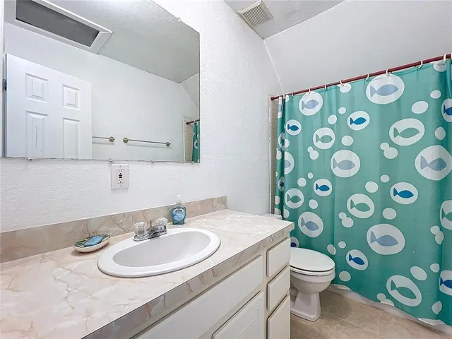 a bathroom with a toilet a sink and a mirror