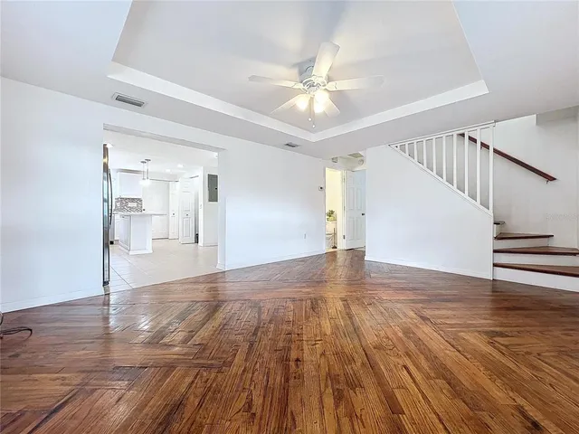 a view of an empty room and wooden floor