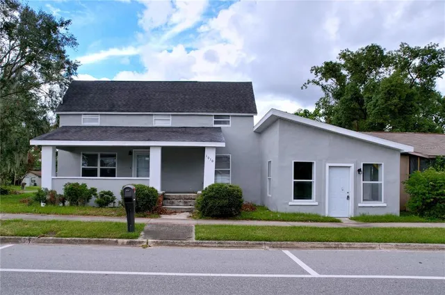 a front view of a house with a garden