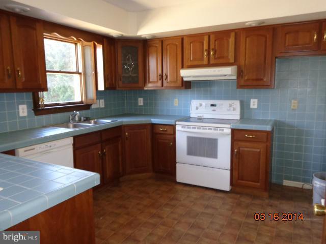 8069 Stone Ridge Drive Frederick, MD 21702 - Photo 3 of 13 a kitchen with stainless steel appliances granite countertop a stove a sink and a microwave
