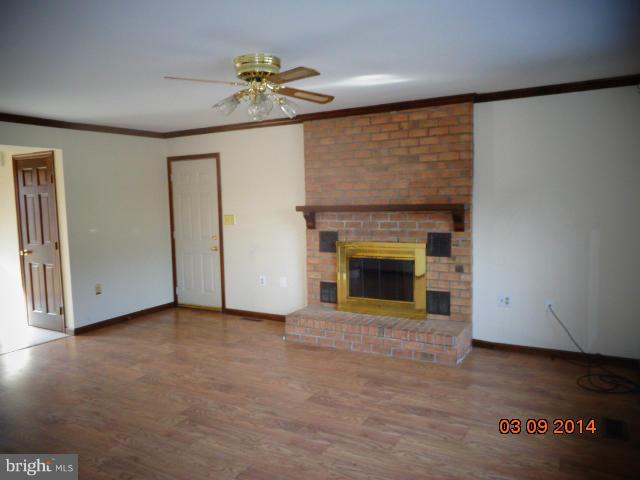 8069 Stone Ridge Drive Frederick, MD 21702 - Photo 4 of 13 a view of an empty room with a fireplace and a window
