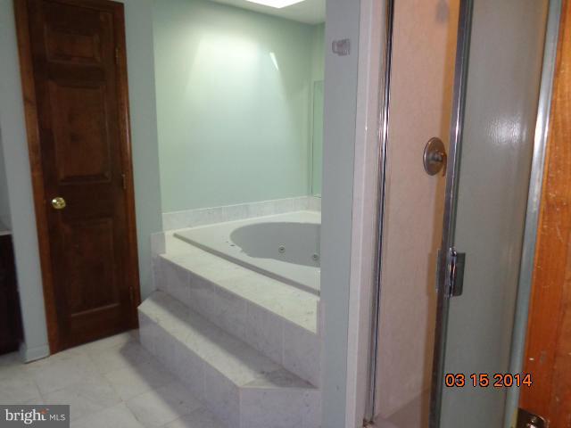 8069 Stone Ridge Drive Frederick, MD 21702 - Photo 10 of 13 a bathroom with a bathtub