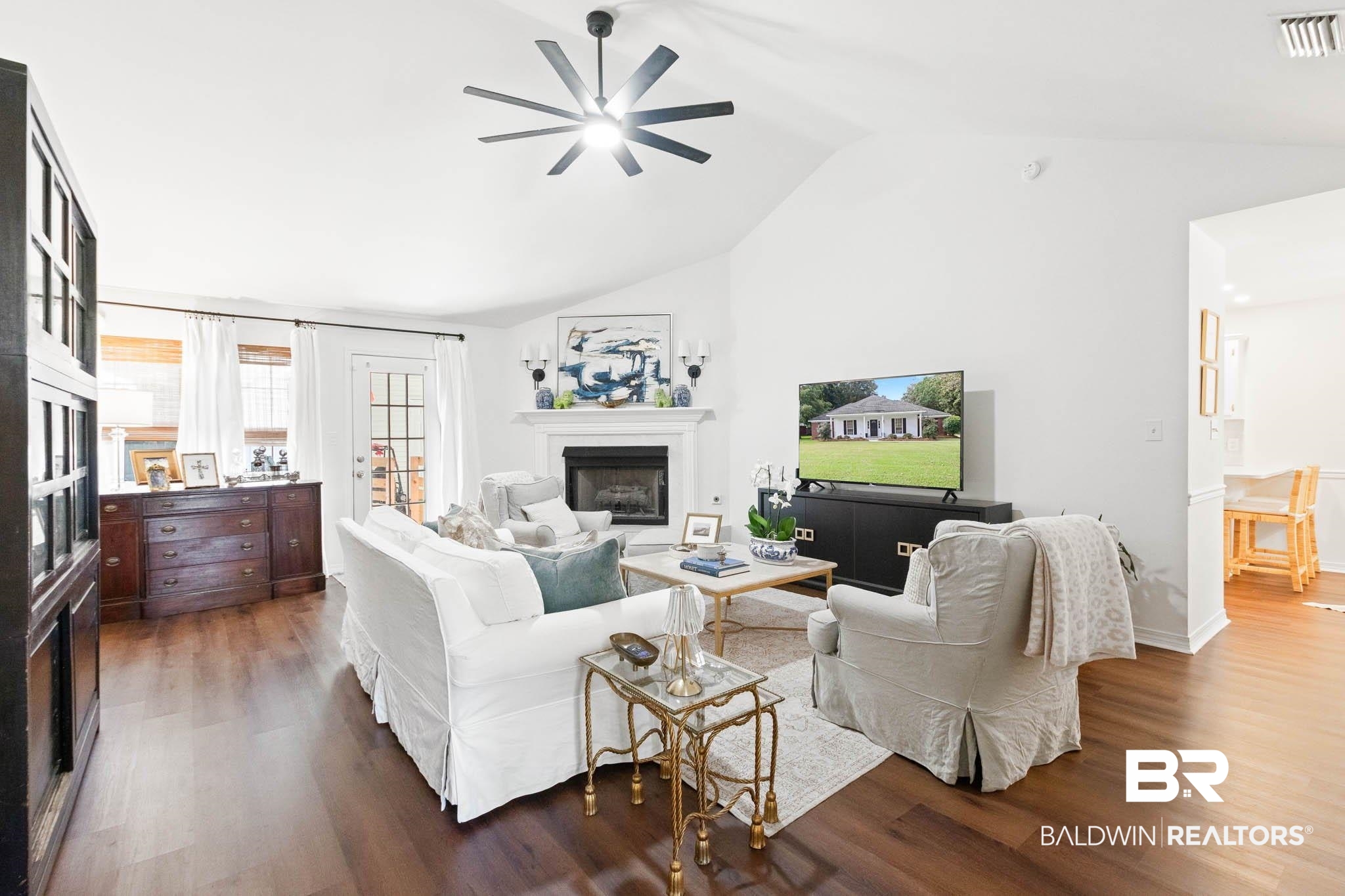 20685 Lowry Drive Fairhope, AL 36532 - Photo 6 of 48 Living area with a glass covered fireplace, dark wood-style floors, ceiling fan, and high vaulted ceiling