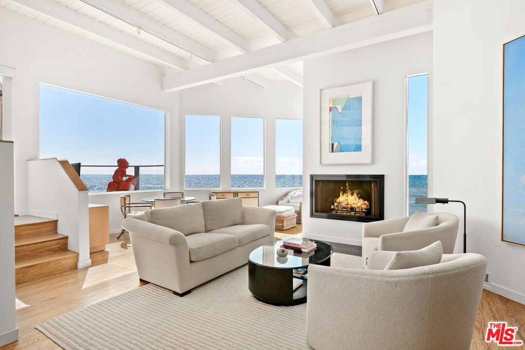 24254 Malibu Road Malibu, CA 90265 - Photo 1 of 26 a living room with furniture and a fireplace