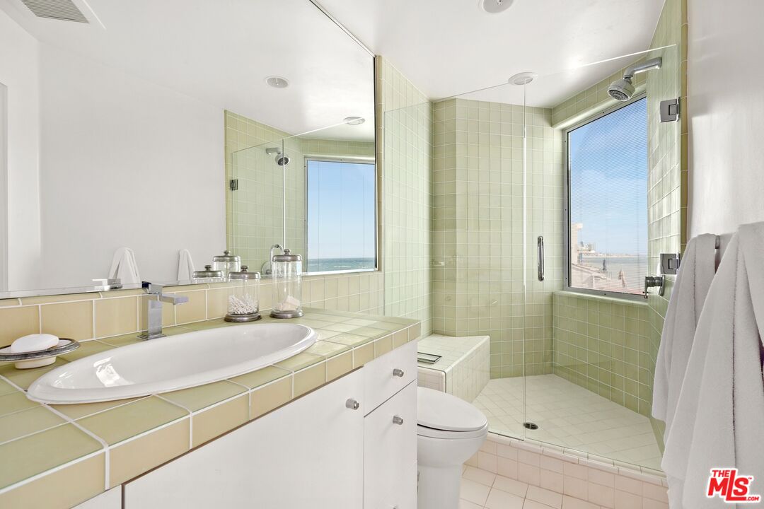 24254 Malibu Road Malibu, CA 90265 - Photo 17 of 26 a bathroom with a sink and mirror with bathtub
