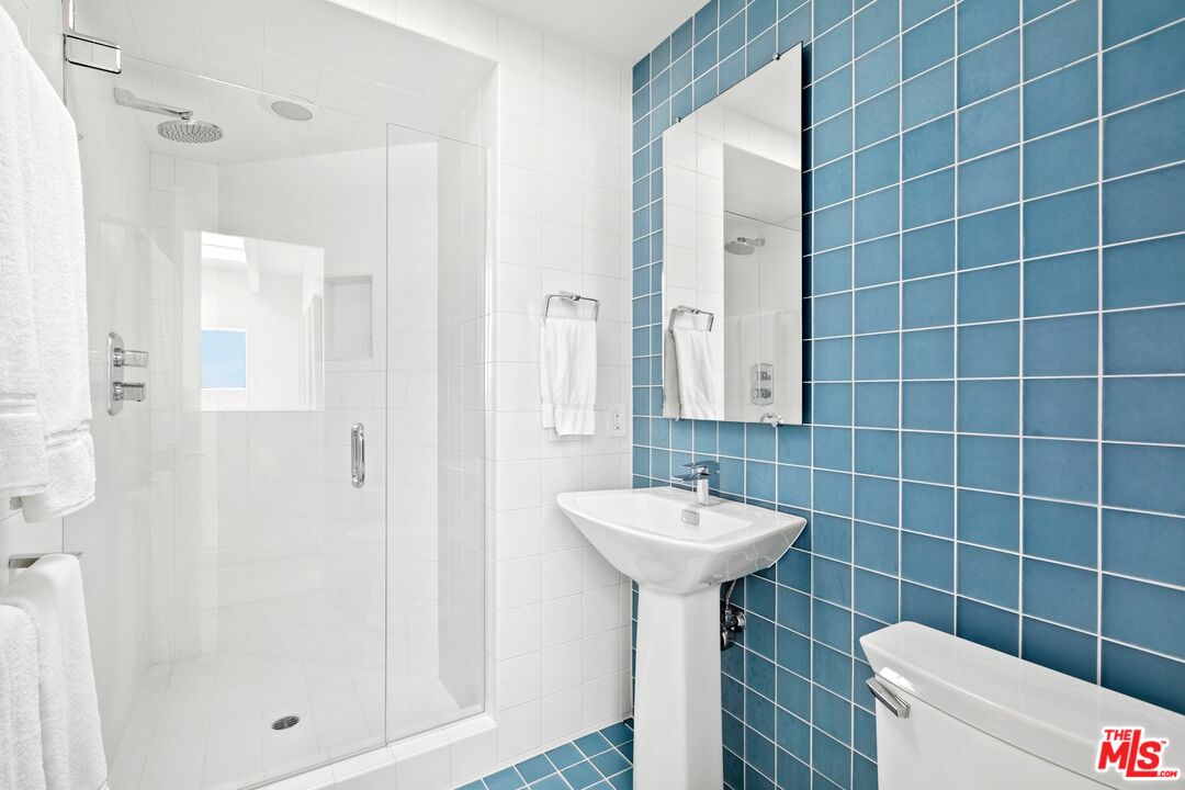 24254 Malibu Road Malibu, CA 90265 - Photo 20 of 26 a bathroom with a sink mirror toilet shower and window