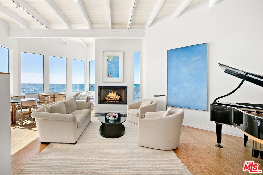 24254 Malibu Road Malibu, CA 90265 - Photo 2 of 26 a living room with furniture and a fireplace