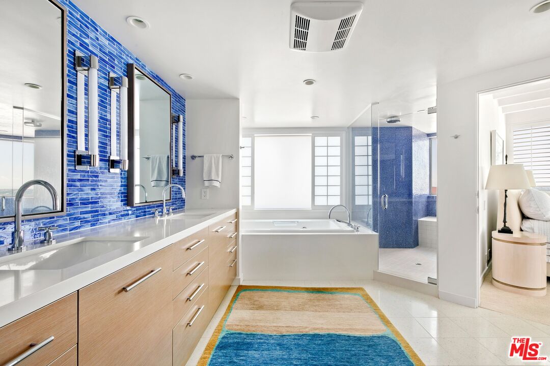 24254 Malibu Road Malibu, CA 90265 - Photo 10 of 26 a spacious bathroom with a tub sink and mirror