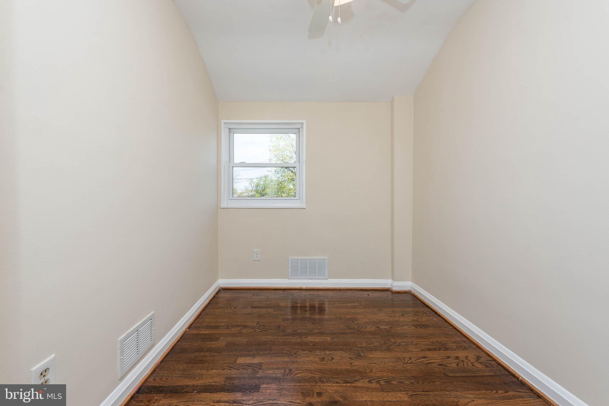 3300 Wallford Drive Baltimore, MD 21222 - Photo 18 of 31 a view of an empty room with wooden floor and a window