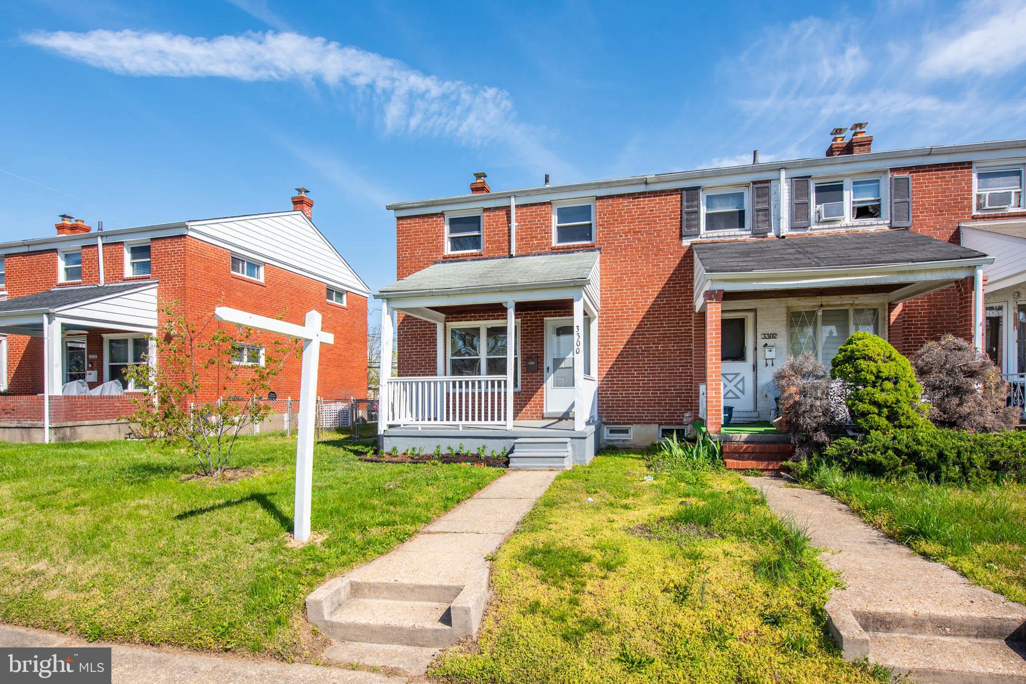3300 Wallford Drive Baltimore, MD 21222 - Photo 26 of 31 front view of a brick house with a yard