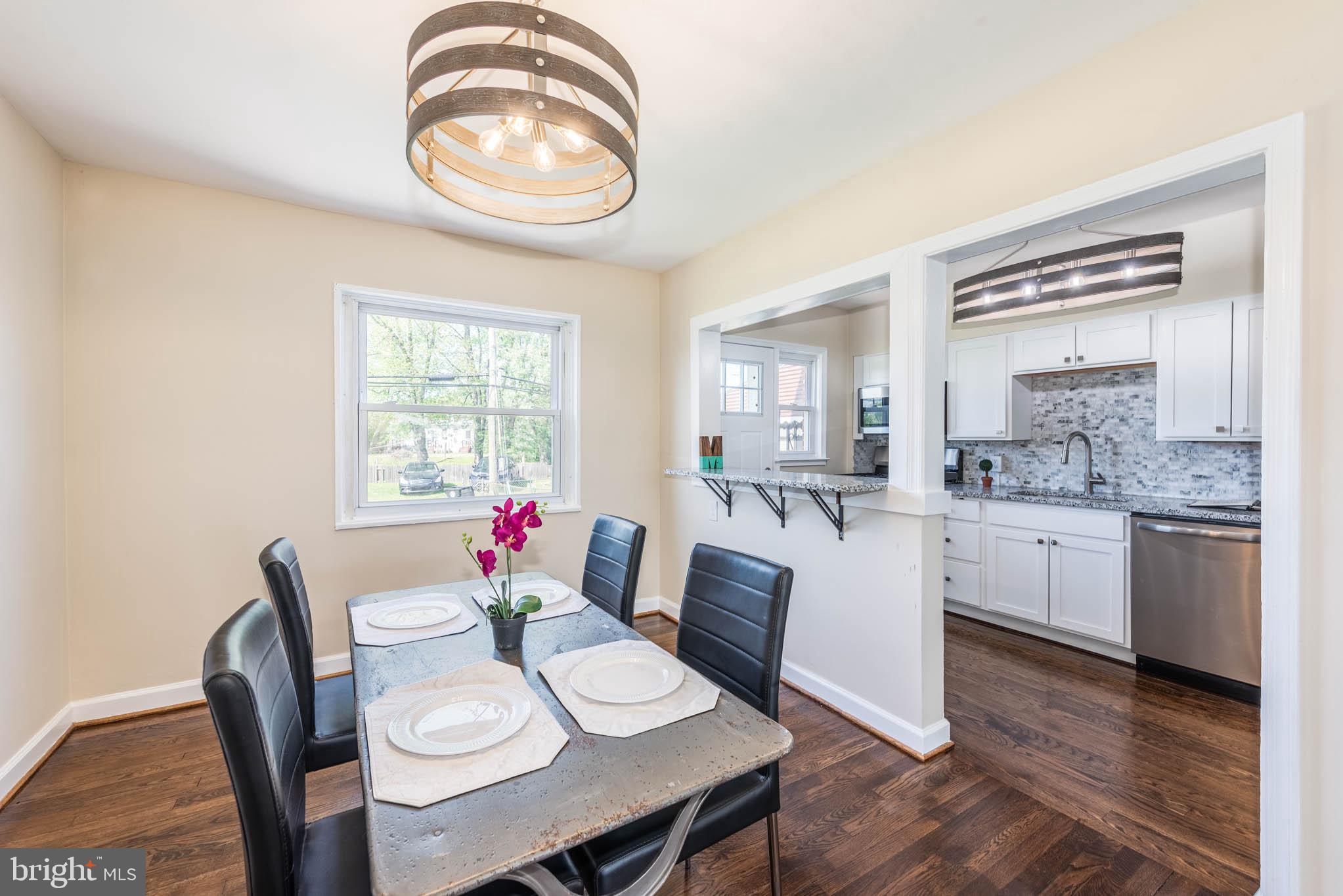 3300 Wallford Drive Baltimore, MD 21222 - Photo 7 of 31 a kitchen with a dining table chairs and white cabinets