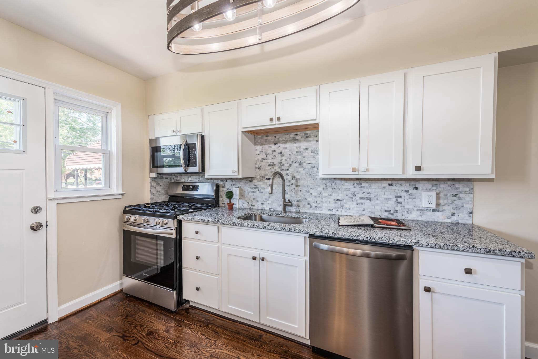 3300 Wallford Drive Baltimore, MD 21222 - Photo 9 of 31 a kitchen with stainless steel appliances granite countertop a sink stove and cabinets