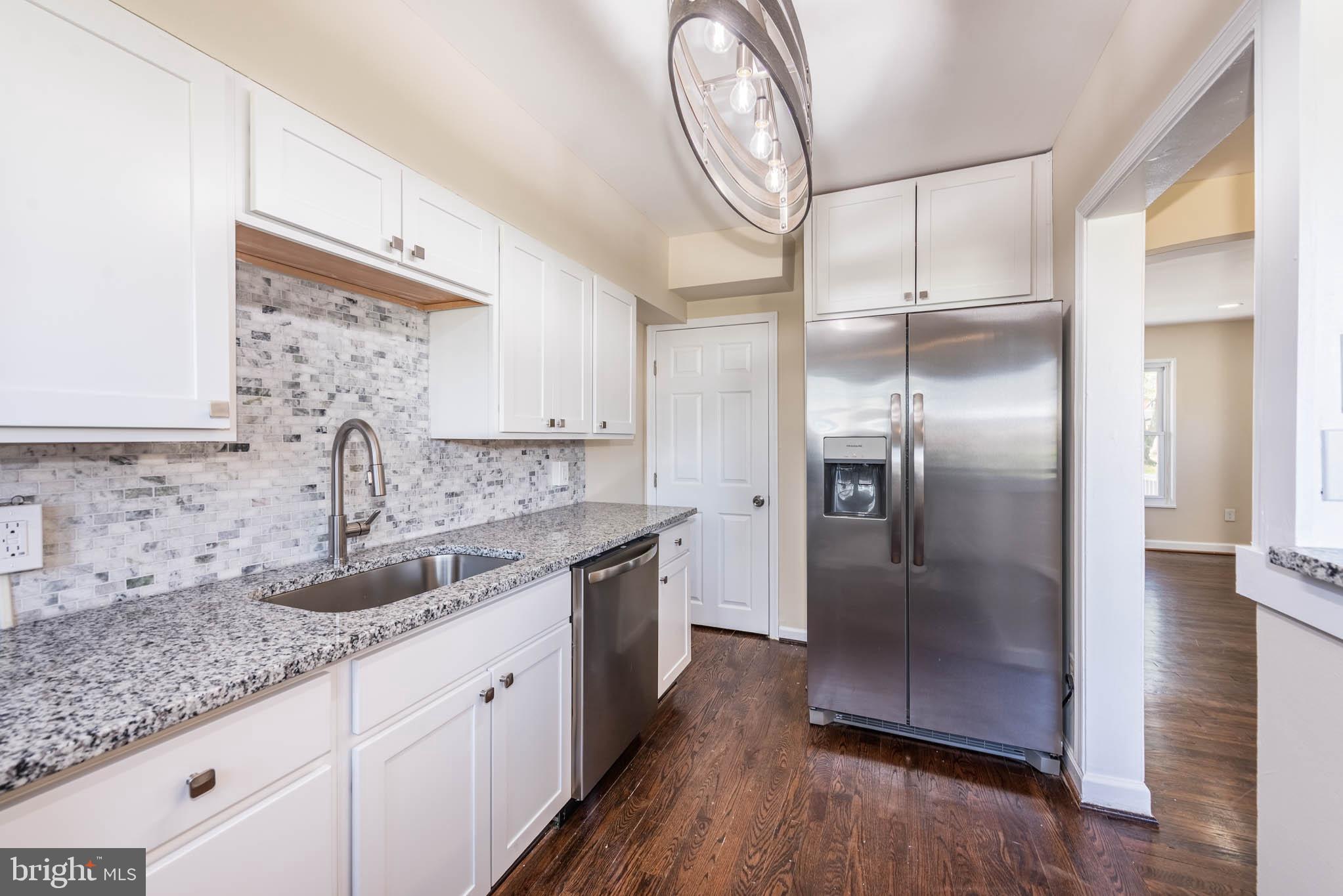 3300 Wallford Drive Baltimore, MD 21222 - Photo 10 of 31 a kitchen with stainless steel appliances granite countertop a sink and a refrigerator