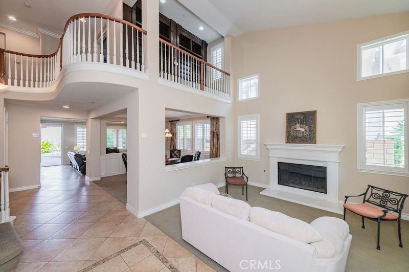 2148 Sageleaf Circle Corona, CA 92882 - Photo 15 of 41 a living room with furniture a fireplace and a flat screen tv