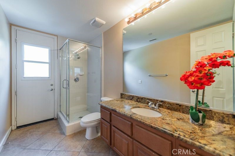 2148 Sageleaf Circle Corona, CA 92882 - Photo 22 of 41 a bathroom with a granite countertop sink a toilet and shower