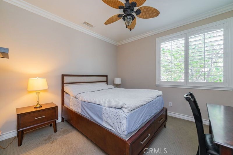 2148 Sageleaf Circle Corona, CA 92882 - Photo 23 of 41 a bedroom with a bed and a chandelier