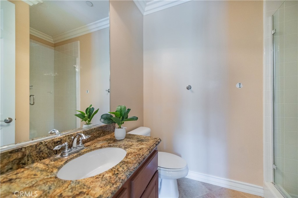 2148 Sageleaf Circle Corona, CA 92882 - Photo 28 of 41 a bathroom with a granite countertop sink a toilet and a mirror