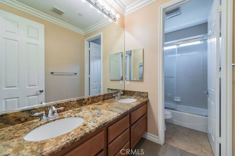 2148 Sageleaf Circle Corona, CA 92882 - Photo 29 of 41 a bathroom with a granite countertop sink and a mirror