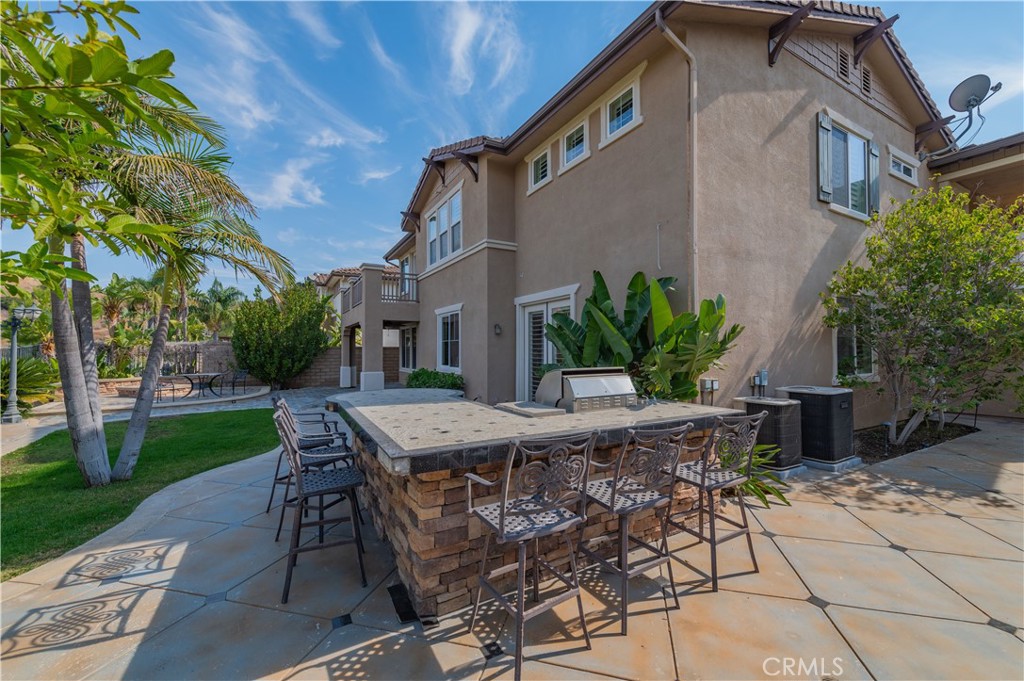 2148 Sageleaf Circle Corona, CA 92882 - Photo 39 of 41 a view of a patio with table and chairs and potted plants