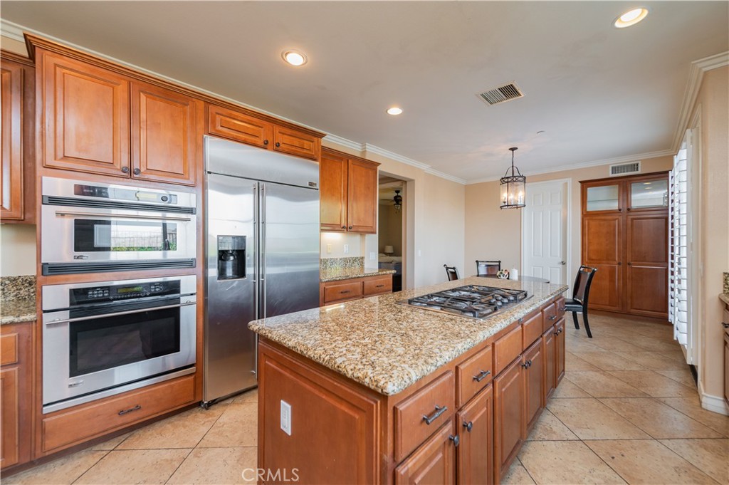 2148 Sageleaf Circle Corona, CA 92882 - Photo 6 of 41 a kitchen with stainless steel appliances granite countertop a stove refrigerator and cabinets