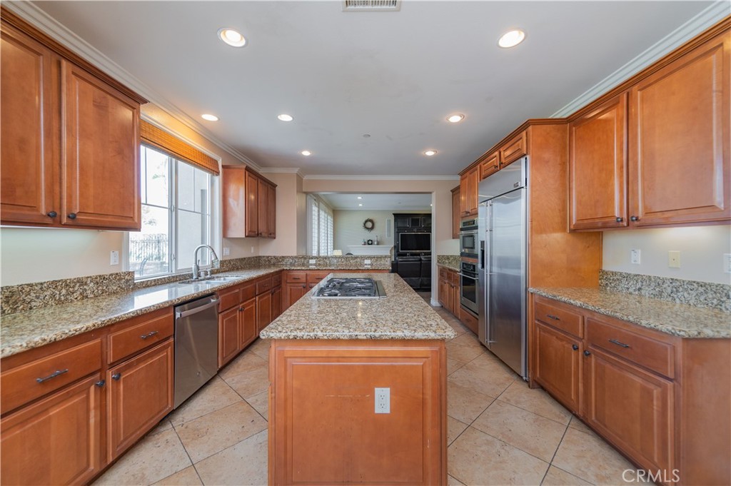 2148 Sageleaf Circle Corona, CA 92882 - Photo 8 of 41 a kitchen with stainless steel appliances granite countertop a sink counter space cabinets and a large window