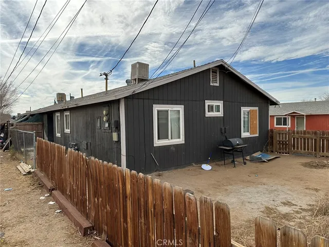a backyard of a house with table and chairs