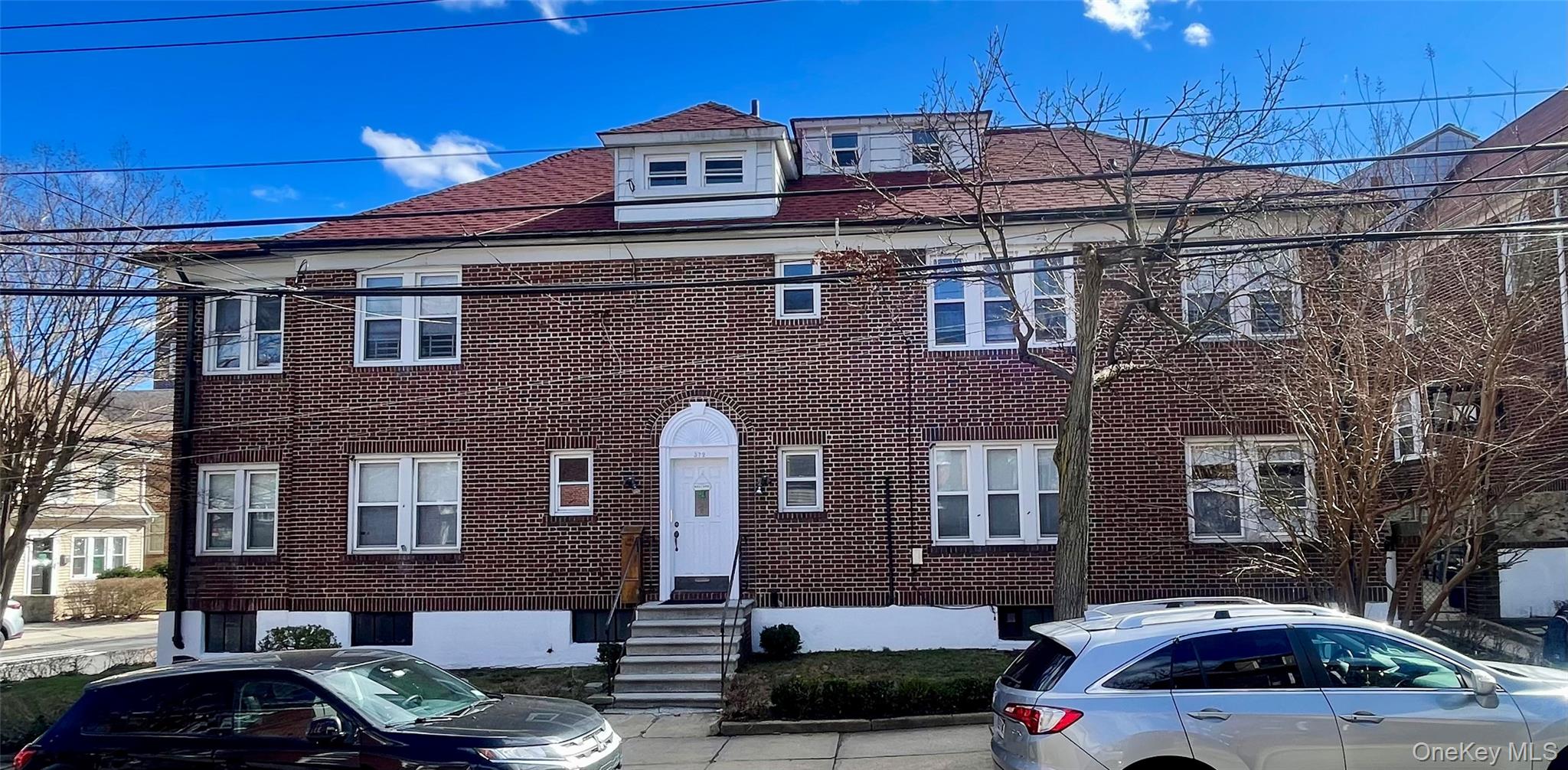 372 East 235th Street Bronx, NY 10470 - Photo 1 of 36 a front view of a building with multiple cars parked